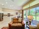 Bright and airy living space features a kitchen, dining area and sliding glass doors to the outdoors at 2274 Foliage Oak Ter, Oviedo, FL 32766