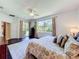 Spacious main bedroom with large windows overlooking the manicured backyard and access to a private patio at 2274 Foliage Oak Ter, Oviedo, FL 32766