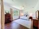 Cozy main bedroom with hardwood floors, a ceiling fan, and a large window at 2274 Foliage Oak Ter, Oviedo, FL 32766