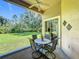Relaxing outdoor patio features a table with seating, overlooking the green backyard at 2274 Foliage Oak Ter, Oviedo, FL 32766