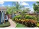 Lush backyard featuring colorful landscaping and a brick pathway to the shed at 2312 S Summerlin Ave, Orlando, FL 32806