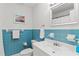 Bright bathroom featuring blue tile accents, a modern sink, and a clean aesthetic at 2312 S Summerlin Ave, Orlando, FL 32806