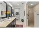 A bathroom with dual sinks, a walk-in shower, and a separate toilet area, all with tile floors at 2312 S Summerlin Ave, Orlando, FL 32806