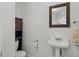 A well-maintained bathroom featuring a pedestal sink, toilet and vanity at 2312 S Summerlin Ave, Orlando, FL 32806