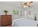 Bedroom with hardwood floors, neutral bedding, and a view of outdoor greenery at 2312 S Summerlin Ave, Orlando, FL 32806