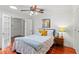 Comfortable bedroom with ceiling fan, bedside table, and doorway to hall at 2312 S Summerlin Ave, Orlando, FL 32806
