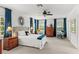 Inviting bedroom filled with natural light from large windows, plus carpet floors, and neutral paint at 2312 S Summerlin Ave, Orlando, FL 32806