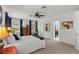 Well-lit bedroom featuring carpeted floors, a ceiling fan, two windows, and neutral paint at 2312 S Summerlin Ave, Orlando, FL 32806