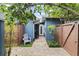 Private courtyard featuring a quaint seating area, lush landscaping, and a charming brick pathway at 2312 S Summerlin Ave, Orlando, FL 32806