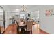 The dining room is open to the living room and kitchen, featuring a beautiful chandelier, hardwood floors and natural light at 2312 S Summerlin Ave, Orlando, FL 32806