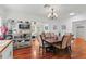 The dining area is open to the living room and has a lovely chandelier to brighten up the hardwood floors at 2312 S Summerlin Ave, Orlando, FL 32806