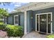 Exterior shot of home with address, black door, white trim, and manicured bushes at 2312 S Summerlin Ave, Orlando, FL 32806