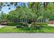 Beautiful home featuring a lush, green front yard with mature trees and manicured landscaping at 2312 S Summerlin Ave, Orlando, FL 32806