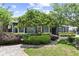 Charming single-story home featuring professional landscaping with mature trees and a brick walkway leading to the entrance at 2312 S Summerlin Ave, Orlando, FL 32806