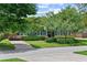 Charming home featuring a well-maintained front yard with mature trees and manicured landscaping at 2312 S Summerlin Ave, Orlando, FL 32806