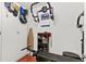 Home gym featuring workout equipment, storage cabinets, and an ironing board for post-workout attire at 2312 S Summerlin Ave, Orlando, FL 32806