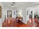 Bright hallway featuring gleaming hardwood floors, modern lighting, and neutral decor at 2312 S Summerlin Ave, Orlando, FL 32806