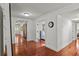 Hallway with hardwood floors, white trim, and access to multiple rooms; bright and open floor plan at 2312 S Summerlin Ave, Orlando, FL 32806