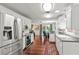 Spacious kitchen with stainless steel appliances, white cabinets, and a view to the backyard at 2312 S Summerlin Ave, Orlando, FL 32806