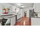 Bright kitchen featuring white cabinets, hardwood floors, and a view into a butler's pantry at 2312 S Summerlin Ave, Orlando, FL 32806