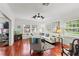 Cozy living room with hardwood floors, a fireplace, and ample natural light at 2312 S Summerlin Ave, Orlando, FL 32806