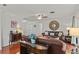 Bright living room featuring hardwood floors, ceiling fan, and cozy leather seating at 2312 S Summerlin Ave, Orlando, FL 32806