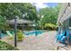 Backyard pool area featuring a pergola, patio, and tropical landscaping at 2312 S Summerlin Ave, Orlando, FL 32806