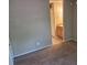 View of the carpeted bedroom leading to the bathroom at 236 Afton Sq # 207, Altamonte Springs, FL 32714