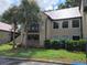 Exterior of the apartment building with mature landscaping at 236 Afton Sq # 207, Altamonte Springs, FL 32714