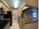 Bright kitchen with stainless appliances, granite counters, and access to a laundry area at 236 Afton Sq # 207, Altamonte Springs, FL 32714