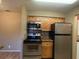 Kitchen with stainless steel appliances and wood cabinets at 236 Afton Sq # 207, Altamonte Springs, FL 32714