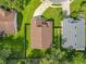 Aerial perspective of a home with manicured lawn highlighting its position among neighboring houses and verdant landscaping at 2489 Tommys Turn, Oviedo, FL 32766