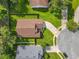 Bird's eye view of a house with a well-maintained yard, showcasing the neighborhood layout and street access at 2489 Tommys Turn, Oviedo, FL 32766