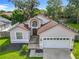 Inviting single-Gathering home featuring a lush green lawn and two-car garage at 2489 Tommys Turn, Oviedo, FL 32766
