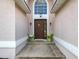 Close up of entry way featuring a solid door and overhead window at 2489 Tommys Turn, Oviedo, FL 32766