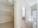 This hallway has a walk-in closet to one side and an open doorway to the bathroom on the other at 2489 Tommys Turn, Oviedo, FL 32766