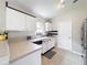 Bright kitchen with white cabinets, modern appliances, and a window over the sink at 2489 Tommys Turn, Oviedo, FL 32766
