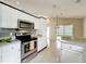 Charming kitchen with white cabinets and stainless steel appliances, leading to outdoor space at 2489 Tommys Turn, Oviedo, FL 32766
