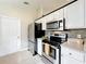 Well-lit kitchen featuring stainless steel appliances and white cabinets at 2489 Tommys Turn, Oviedo, FL 32766