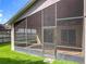 Exterior view of the screened-in lanai and grassy backyard at 2489 Tommys Turn, Oviedo, FL 32766