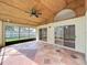 This screened-in lanai has tile flooring and a ceiling fan to help you keep cool during the hot summer months at 2489 Tommys Turn, Oviedo, FL 32766