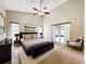 This main bedroom features neutral walls, tile flooring, and sliding glass doors to the home's lanai at 2489 Tommys Turn, Oviedo, FL 32766