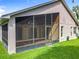 View of a screened-in patio with tiled floors, accessible from inside the home and overlooking the green backyard at 2489 Tommys Turn, Oviedo, FL 32766