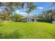 Expansive backyard featuring a lush lawn and a screened-in patio, perfect for outdoor living at 2782 Cedar Knoll Dr, Apopka, FL 32712
