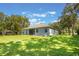 Expansive backyard featuring a screened lanai and a well-maintained lawn, ideal for outdoor entertaining at 2782 Cedar Knoll Dr, Apopka, FL 32712