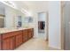 Bathroom featuring double vanity, large mirror, tile flooring and walk in closet at 2782 Cedar Knoll Dr, Apopka, FL 32712