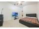 Bedroom with neutral carpet, single bed, and television with decorative wall at 2782 Cedar Knoll Dr, Apopka, FL 32712