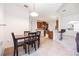 Open concept dining area with tile flooring, arched entryways, and breakfast bar leading into living area at 2782 Cedar Knoll Dr, Apopka, FL 32712