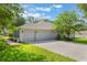 Charming home features a well-manicured lawn and an expansive paver driveway leading to a two-car garage at 2782 Cedar Knoll Dr, Apopka, FL 32712