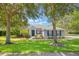 Beautiful home with well-maintained lawn, blue shutters, stone accents, and mature trees at 2782 Cedar Knoll Dr, Apopka, FL 32712